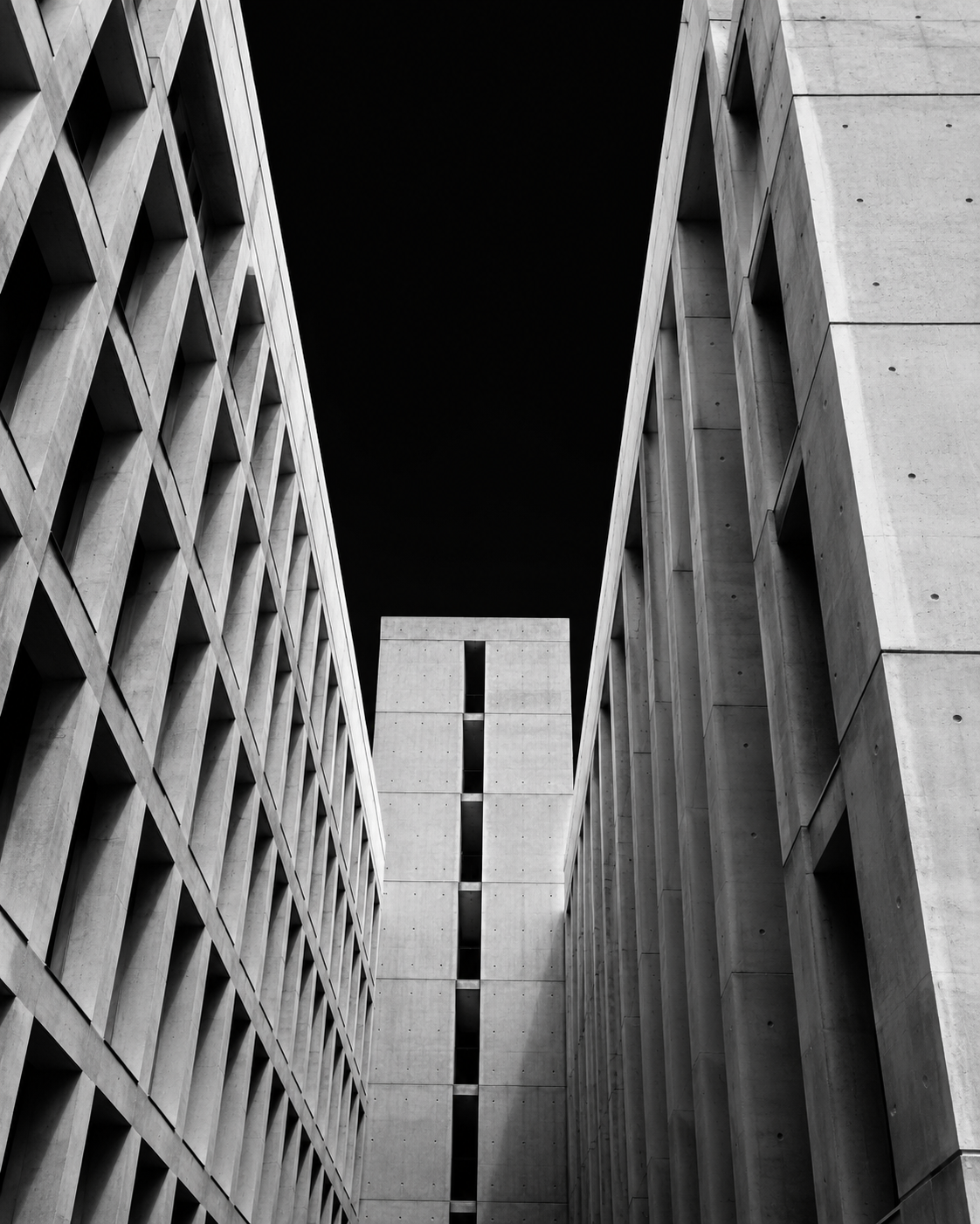 A sunlit architectural courtyard with a clear path through the structure.
