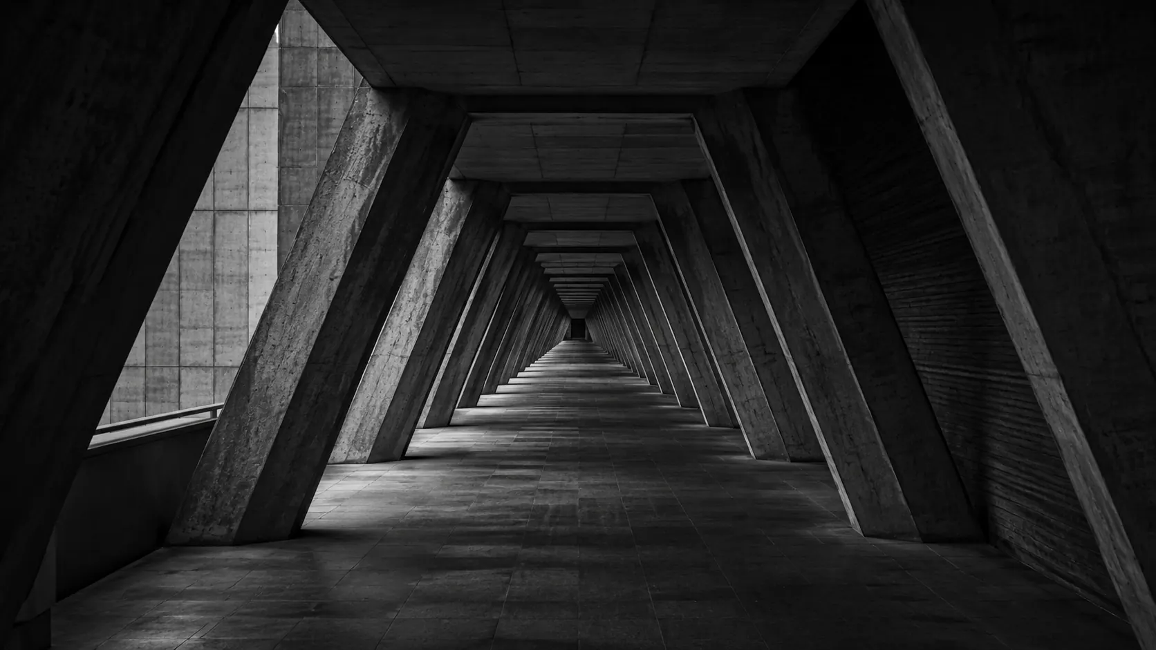 A structured architectural passage opening towards the light.